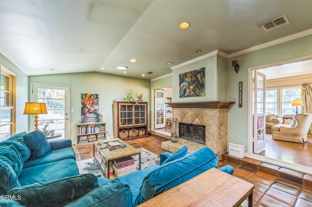 living room with plenty of natural light, a premium fireplace, recessed lighting, crown molding, and lofted ceiling