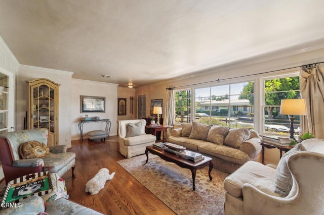 living room featuring crown molding and wood finished floors