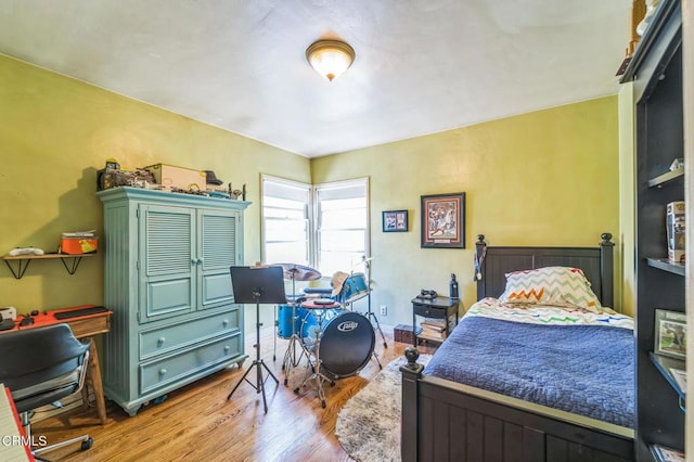 bedroom with wood finished floors and a desk
