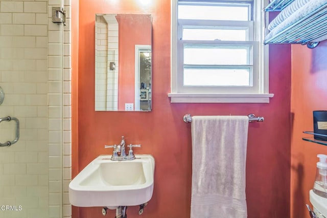 bathroom featuring a sink and an enclosed shower
