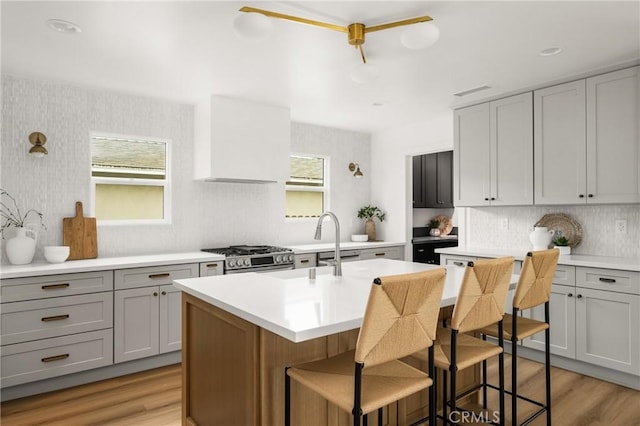2153 Stanbridge Ave, Long Beach, CA 90815 - kitchen featuring stainless steel gas stove, gray cabinets, light wood-style floors, and light countertops