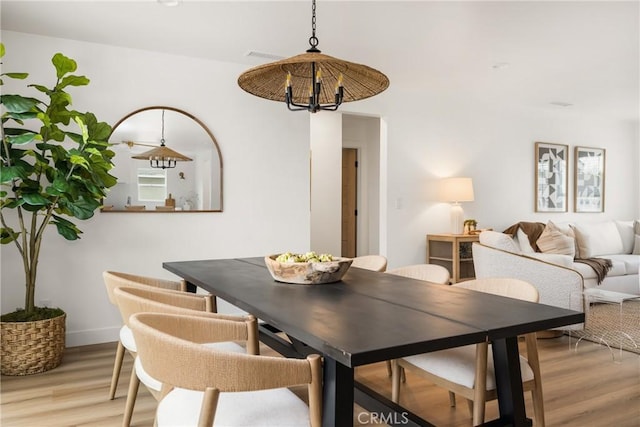 2153 Stanbridge Ave, Long Beach, CA 90815 - dining room with light wood-style flooring, a chandelier, and baseboards