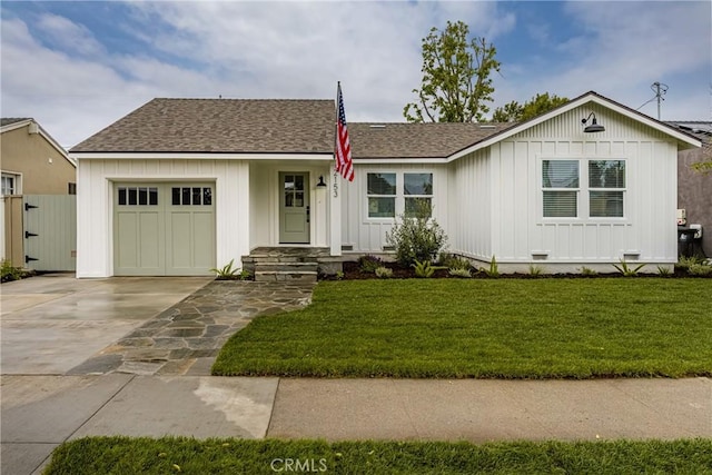 2153 Stanbridge Ave, Long Beach, CA 90815 - ranch-style house featuring an attached garage, board and batten siding, concrete driveway, roof with shingles, and a front yard