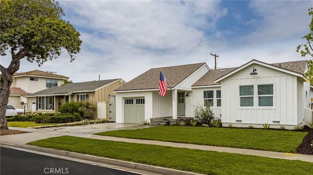 2153 Stanbridge Ave, Long Beach, CA 90815 - view of front of home with board and batten siding, a garage, driveway, a front lawn, and roof with shingles