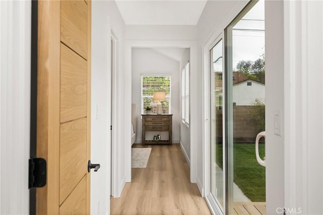 2153 Stanbridge Ave, Long Beach, CA 90815 - doorway to outside with light wood-style flooring, lofted ceiling, and baseboards