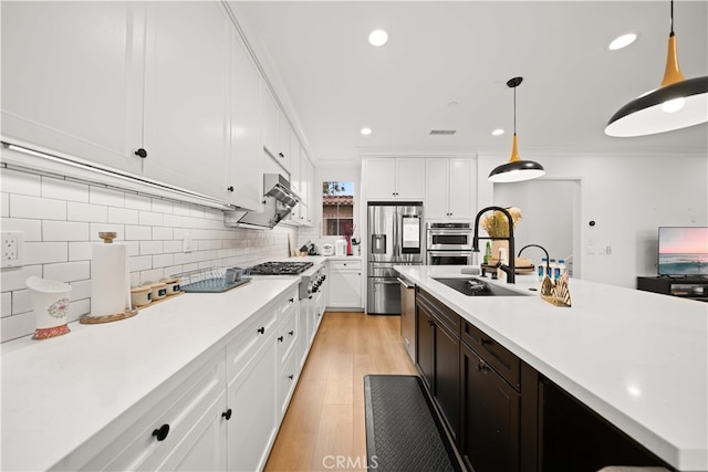 54 Painted Cameo, Irvine, CA 92602 - kitchen featuring stainless steel appliances, a sink, light countertops, white cabinetry, and recessed lighting