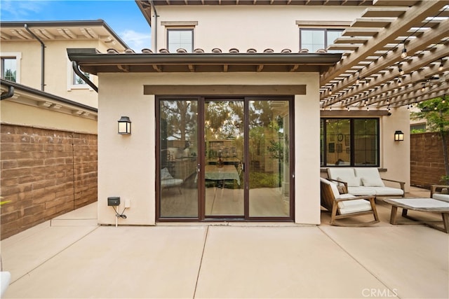 54 Painted Cameo, Irvine, CA 92602 - view of exterior entry with a patio, a pergola, stucco siding, and fence