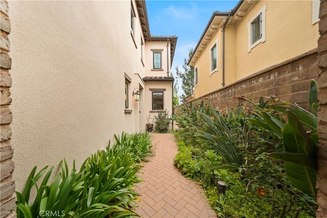 54 Painted Cameo, Irvine, CA 92602 - view of home's exterior featuring stucco siding and a patio area