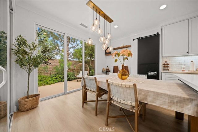54 Painted Cameo, Irvine, CA 92602 - dining area with light wood finished floors, a barn door, recessed lighting, and ornamental molding