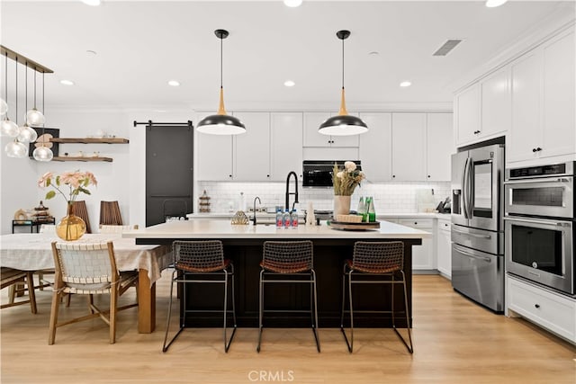 54 Painted Cameo, Irvine, CA 92602 - kitchen featuring appliances with stainless steel finishes, white cabinetry, light countertops, tasteful backsplash, and ornamental molding