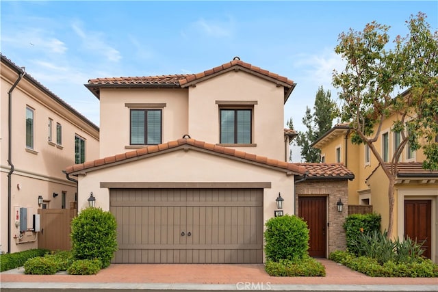 54 Painted Cameo, Irvine, CA 92602 - mediterranean / spanish home featuring a tile roof, an attached garage, stucco siding, and driveway