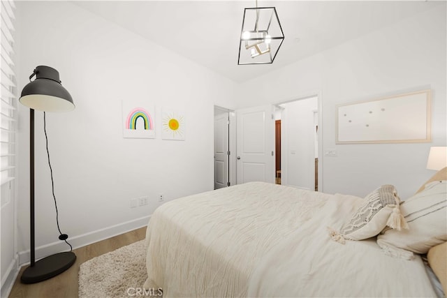 54 Painted Cameo, Irvine, CA 92602 - bedroom with wood finished floors, baseboards, and a chandelier