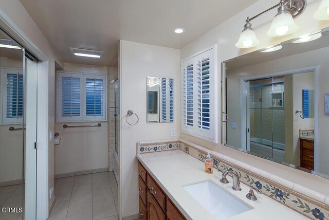 bathroom with tile patterned floors, vanity, baseboards, recessed lighting, and combined bath / shower with glass door