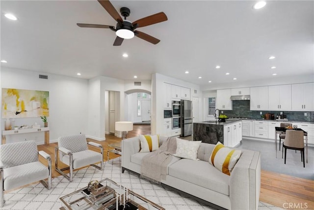 6 Heatherwood, Irvine, CA 92620 - living room featuring recessed lighting, a ceiling fan, arched walkways, light wood-style flooring, and baseboards