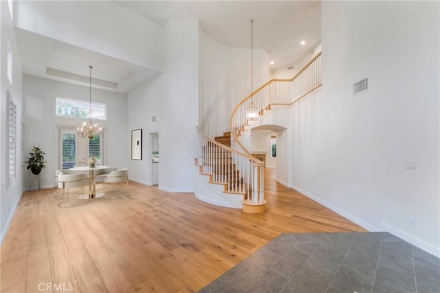 6 Heatherwood, Irvine, CA 92620 - foyer featuring a towering ceiling, wood finished floors, stairs, a chandelier, and baseboards
