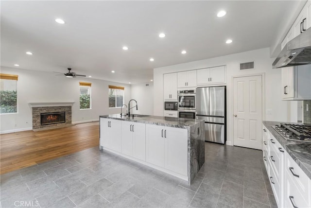 6 Heatherwood, Irvine, CA 92620 - kitchen with appliances with stainless steel finishes, a sink, a ceiling fan, dark stone counters, and recessed lighting