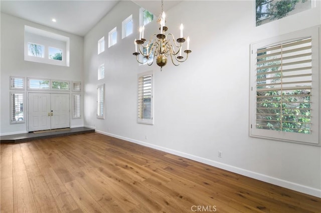 6 Heatherwood, Irvine, CA 92620 - entryway with baseboards, a chandelier, hardwood / wood-style flooring, and a high ceiling