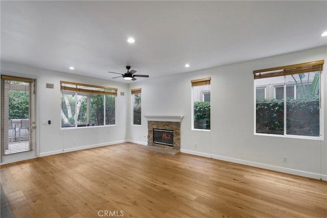 6 Heatherwood, Irvine, CA 92620 - unfurnished living room with a stone fireplace, plenty of natural light, light wood finished floors, and recessed lighting