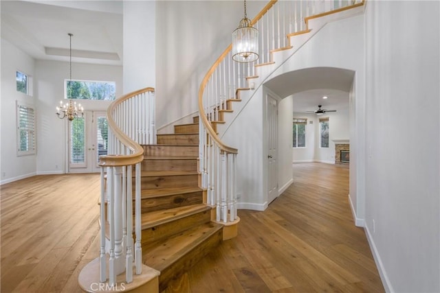 6 Heatherwood, Irvine, CA 92620 - stairway with a high ceiling, wood-type flooring, baseboards, a ceiling fan, and a chandelier