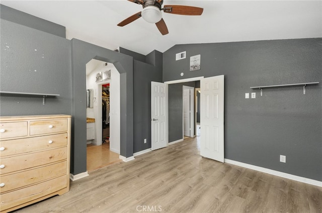 24471 New Haven Dr, Murrieta, CA 92562 - bedroom featuring lofted ceiling, arched walkways, a walk in closet, light wood finished floors, and a closet