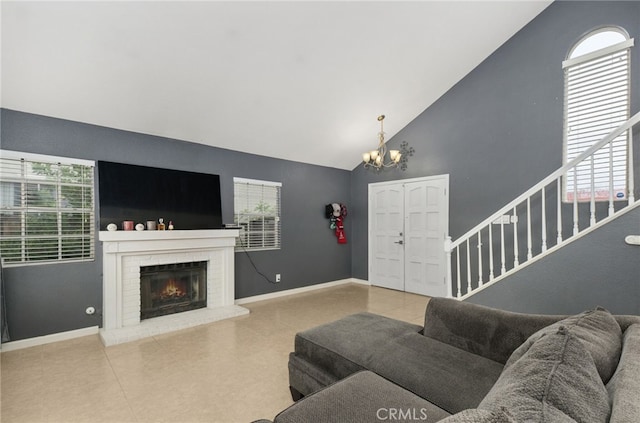 24471 New Haven Dr, Murrieta, CA 92562 - living room featuring a chandelier, high vaulted ceiling, a brick fireplace, baseboards, and stairway