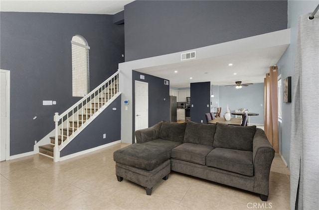 24471 New Haven Dr, Murrieta, CA 92562 - living area with stairway, light tile patterned floors, a ceiling fan, a high ceiling, and recessed lighting