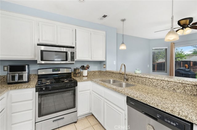 24471 New Haven Dr, Murrieta, CA 92562 - kitchen featuring stainless steel appliances, a sink, white cabinetry, and hanging light fixtures