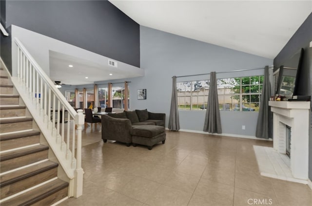 24471 New Haven Dr, Murrieta, CA 92562 - living area featuring stairs, high vaulted ceiling, a fireplace with flush hearth, ceiling fan, and tile patterned flooring