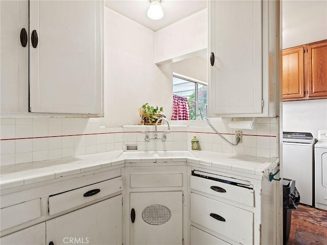 1234 N Ontario St, Burbank, CA 91505 - kitchen with separate washer and dryer, decorative backsplash, a sink, and tile counters