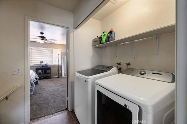 laundry area with separate washer and dryer, ceiling fan, dark carpet, dark tile patterned floors, and baseboards