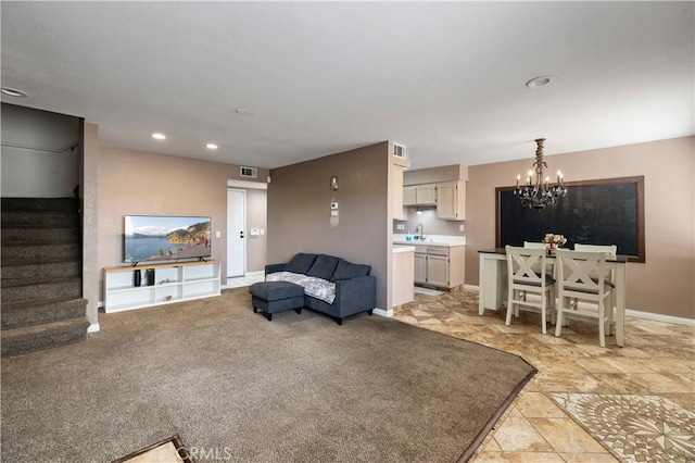 living area with stairway, a chandelier, baseboards, and recessed lighting