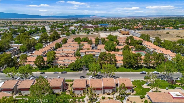 aerial view of property's location featuring nearby suburban area and a mountainous background