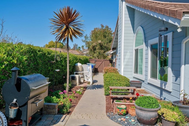 view of side of property featuring a gate and fence