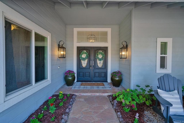 view of exterior entry with a porch