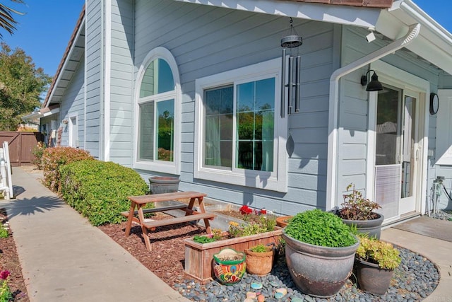 view of side of property featuring fence