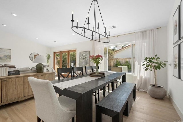 dining room featuring light wood-style flooring, a chandelier, and recessed lighting