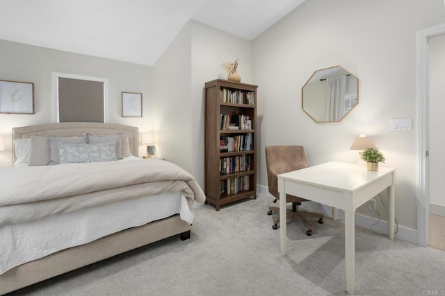 carpeted bedroom featuring vaulted ceiling, an office area, and baseboards