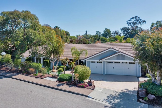ranch-style home featuring a garage, a tiled roof, and driveway