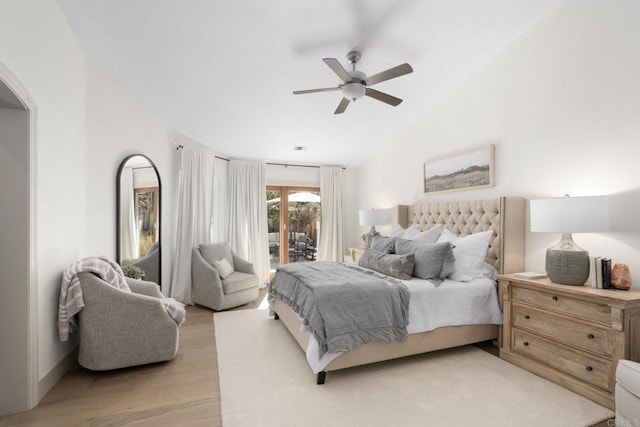 bedroom with access to exterior, light wood finished floors, vaulted ceiling, arched walkways, and ceiling fan
