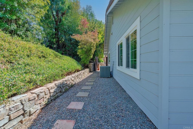 view of side of home with central AC unit