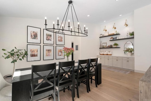 dining area with light wood-style flooring, a chandelier, and recessed lighting