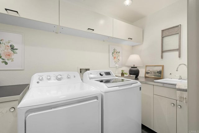 laundry area featuring washing machine and clothes dryer and cabinet space