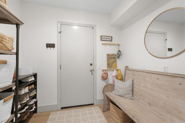 mudroom featuring light wood-style floors and baseboards