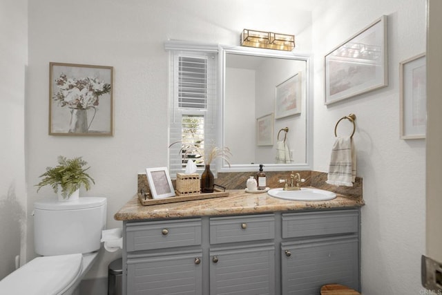 bathroom featuring toilet and vanity