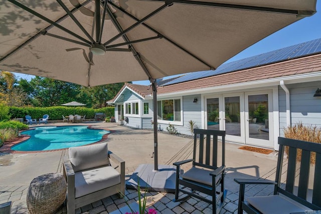 view of swimming pool with french doors and a patio