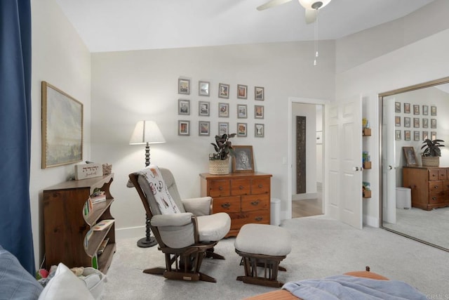 sitting room featuring lofted ceiling, carpet floors, ceiling fan, and baseboards