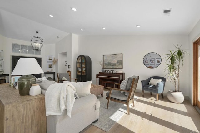 living room with vaulted ceiling, light wood-style floors, baseboards, a chandelier, and recessed lighting