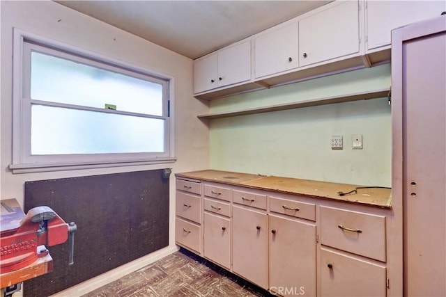 kitchen featuring open shelves, light countertops, and white cabinets