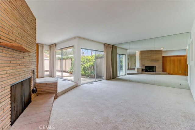 2175 Queensberry Rd, Pasadena, CA 91104 - unfurnished living room featuring a brick fireplace, carpet flooring, and healthy amount of natural light