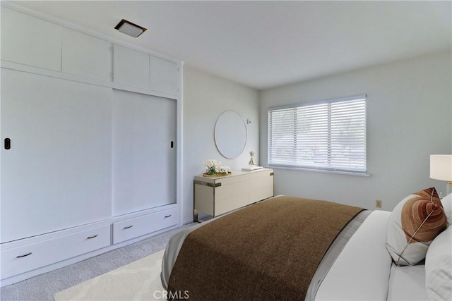 carpeted bedroom with a closet